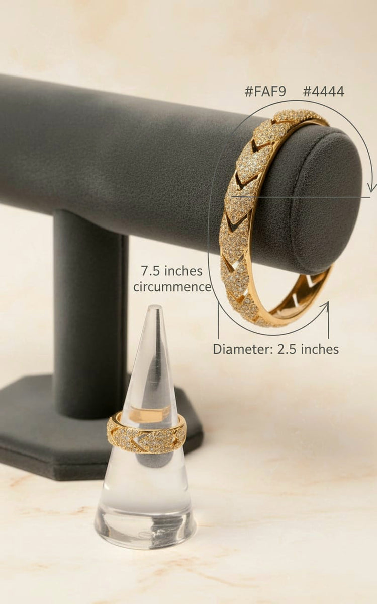Gold bracelet on a black stand with measurements displayed