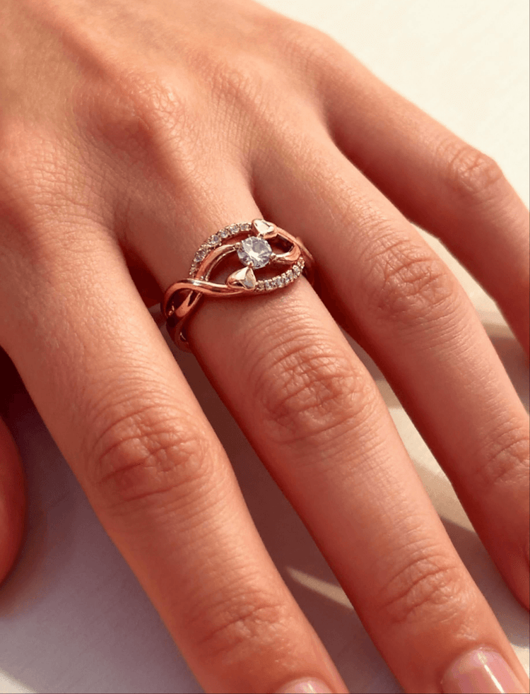 Rose gold ring with a diamond on a person&