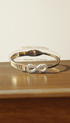 Gold bracelet with infinity symbol on a wooden surface