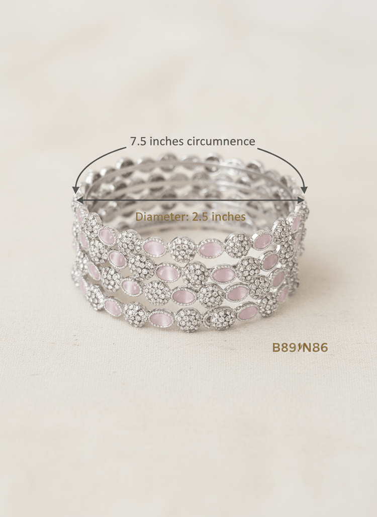 Silver bracelet with pink stones on a beige background, showing measurements and product code.