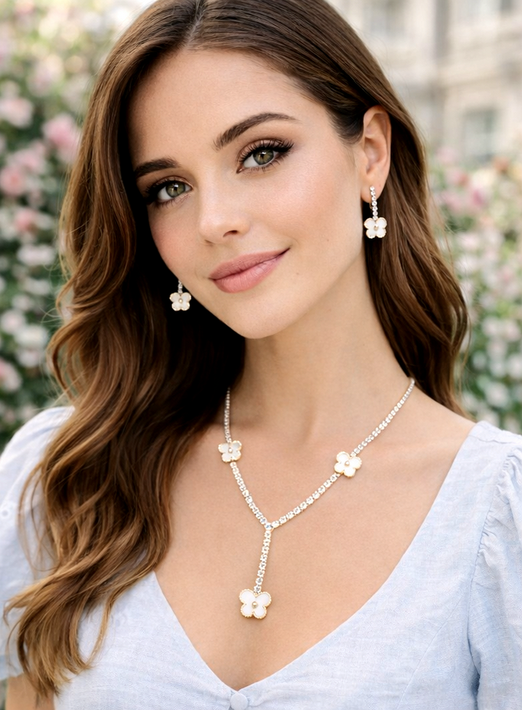 Woman wearing a floral necklace and earrings with a blurred floral background