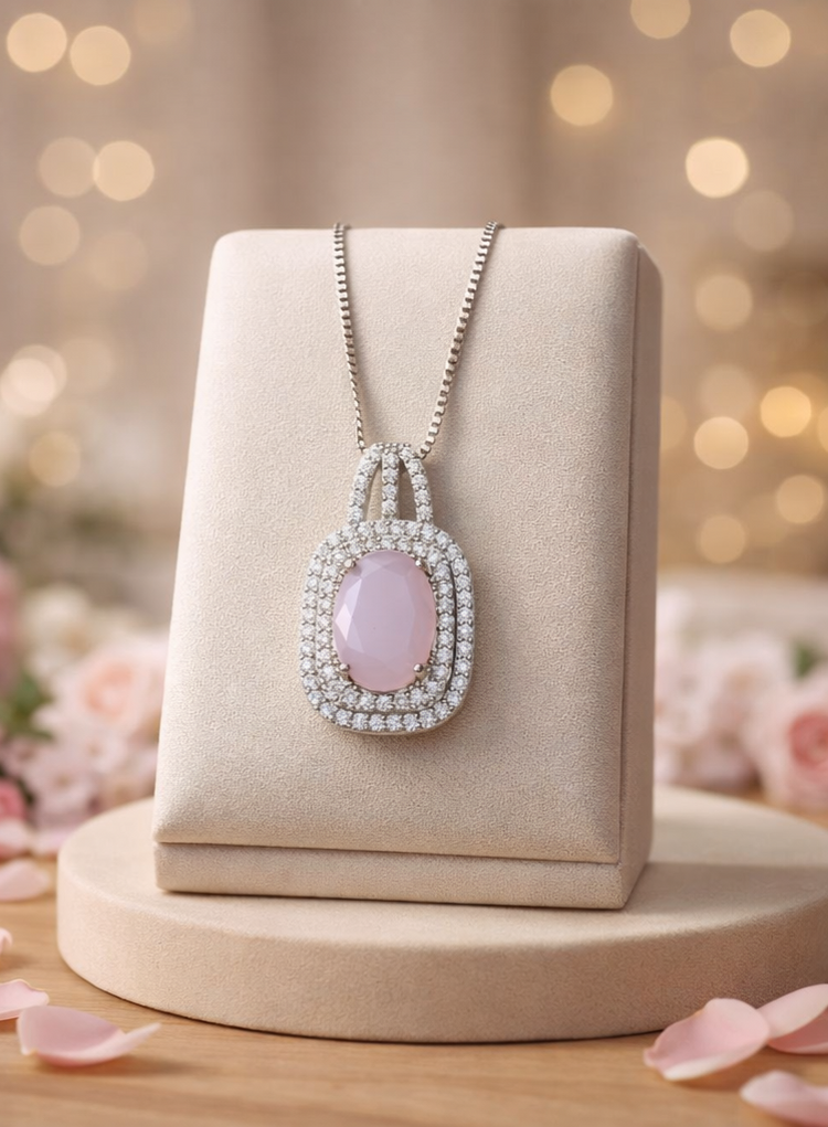 Necklace with a pink pendant on a beige stand with a soft, blurred background
