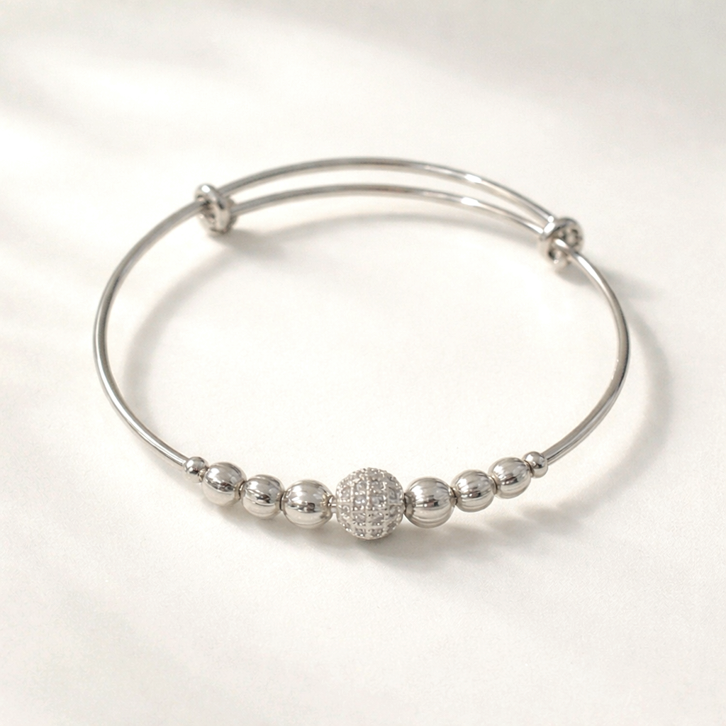 Silver bracelet with spherical beads on a white background