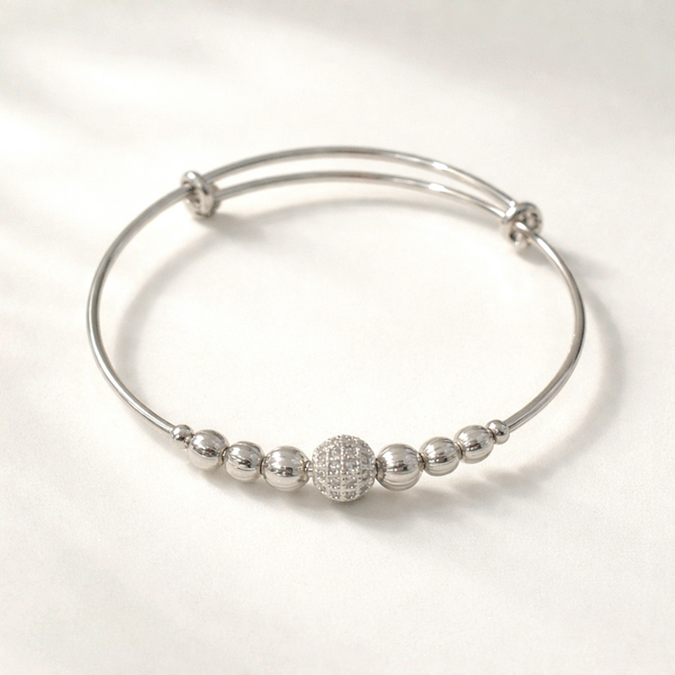 Silver bracelet with spherical beads on a white background
