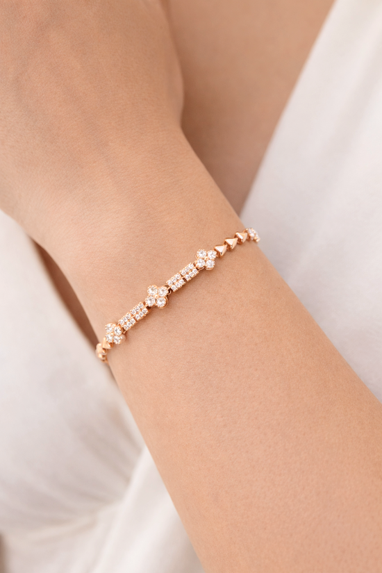 Rose gold bracelet with clear stones on a person&