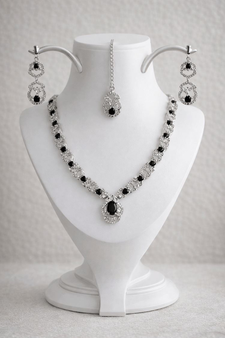 Jewelry set with necklace and earrings on a white mannequin bust.