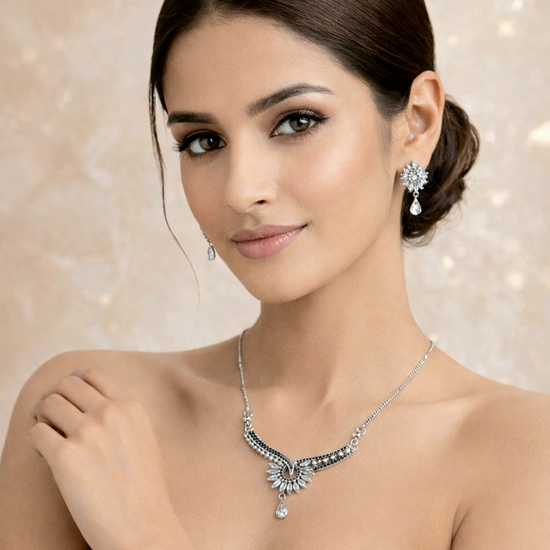 Woman wearing a necklace and earrings with a soft background