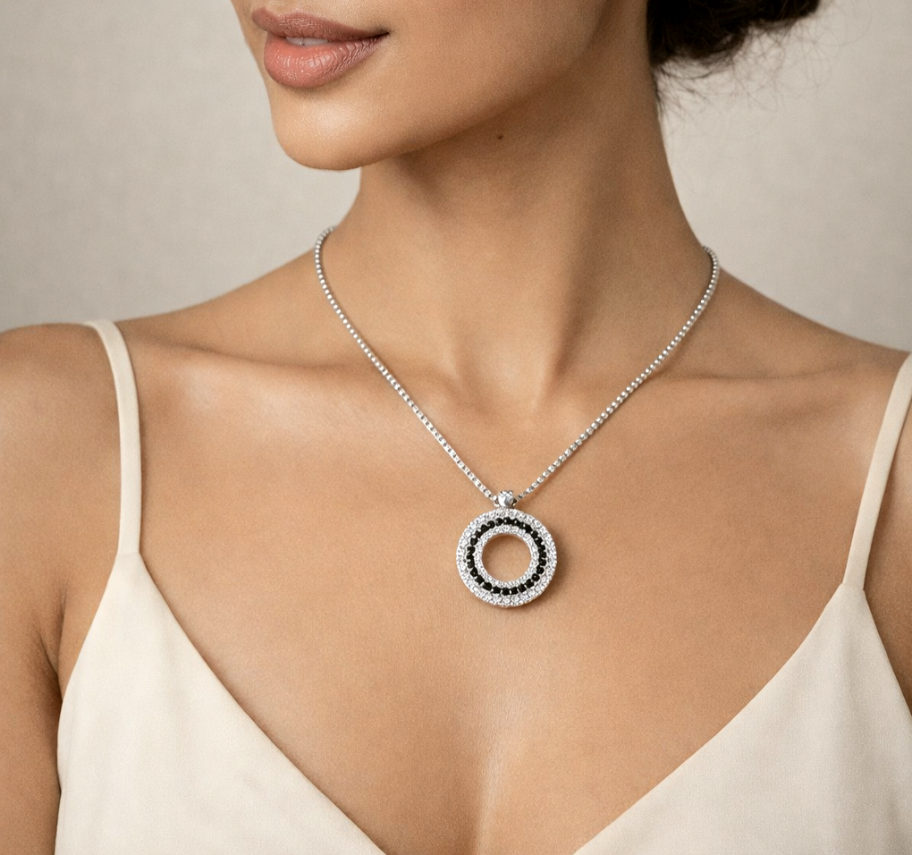 Necklace with a circular pendant worn by a model against a neutral background