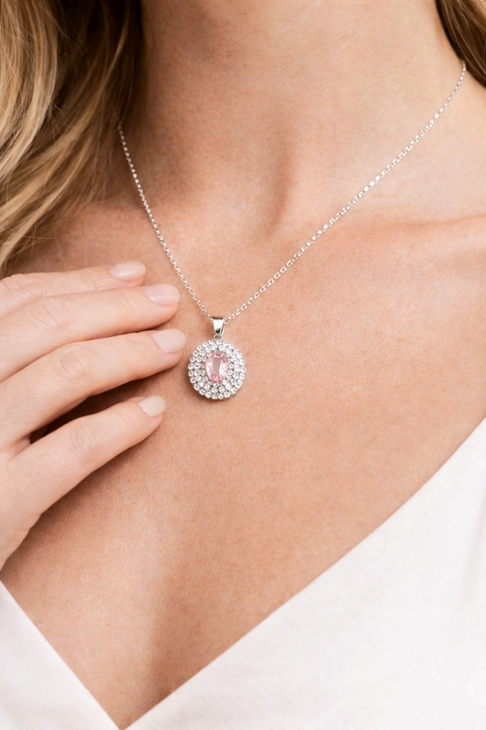 Necklace with a pink pendant worn by a person