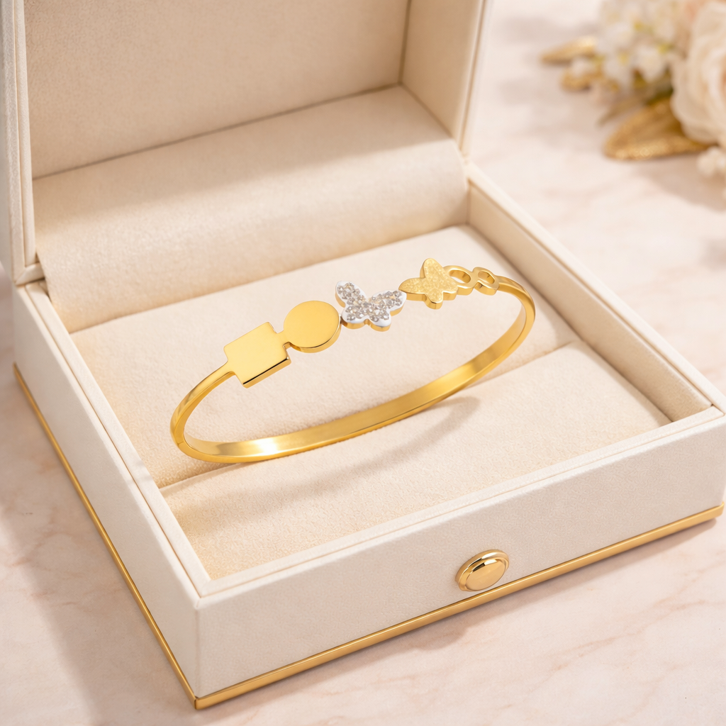 Gold bracelet with star and heart charms in a jewelry box