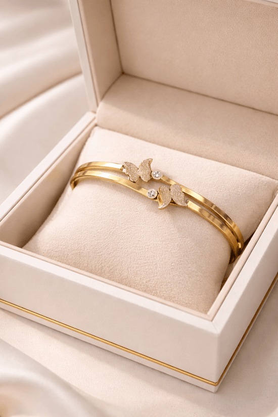 Gold bracelet with butterfly design in a jewelry box