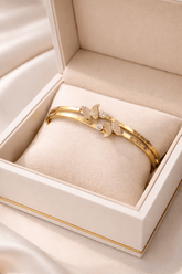 Gold bracelet with butterfly design in a jewelry box