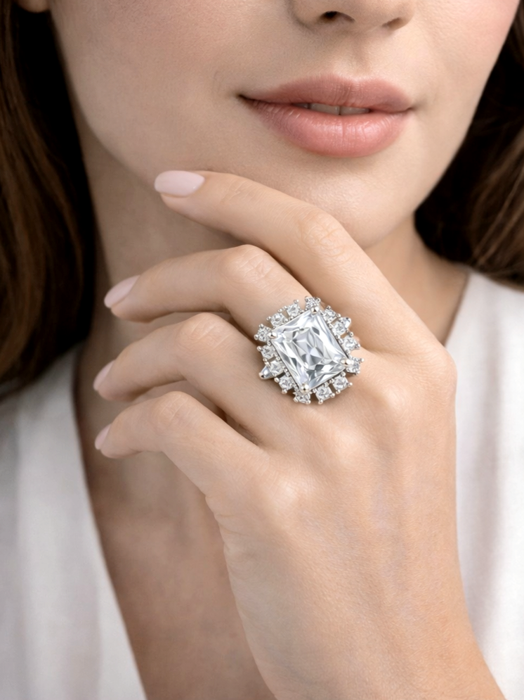 Close-up of a hand wearing a diamond ring with a blurred background