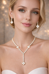 Woman wearing a pearl necklace and earrings with a soft focus background