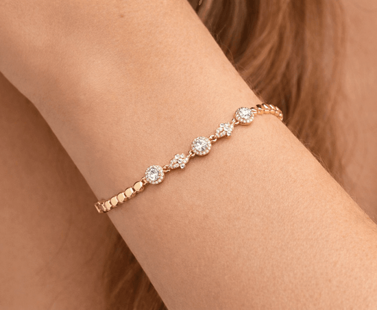 Rose gold bracelet with clear stones on a wrist