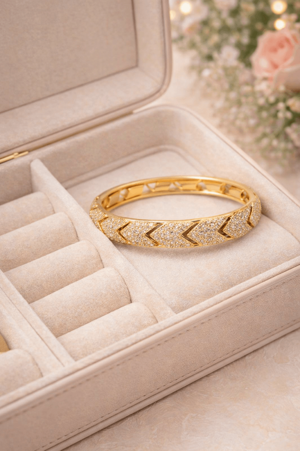 Gold bracelet in a jewelry box with a soft focus background