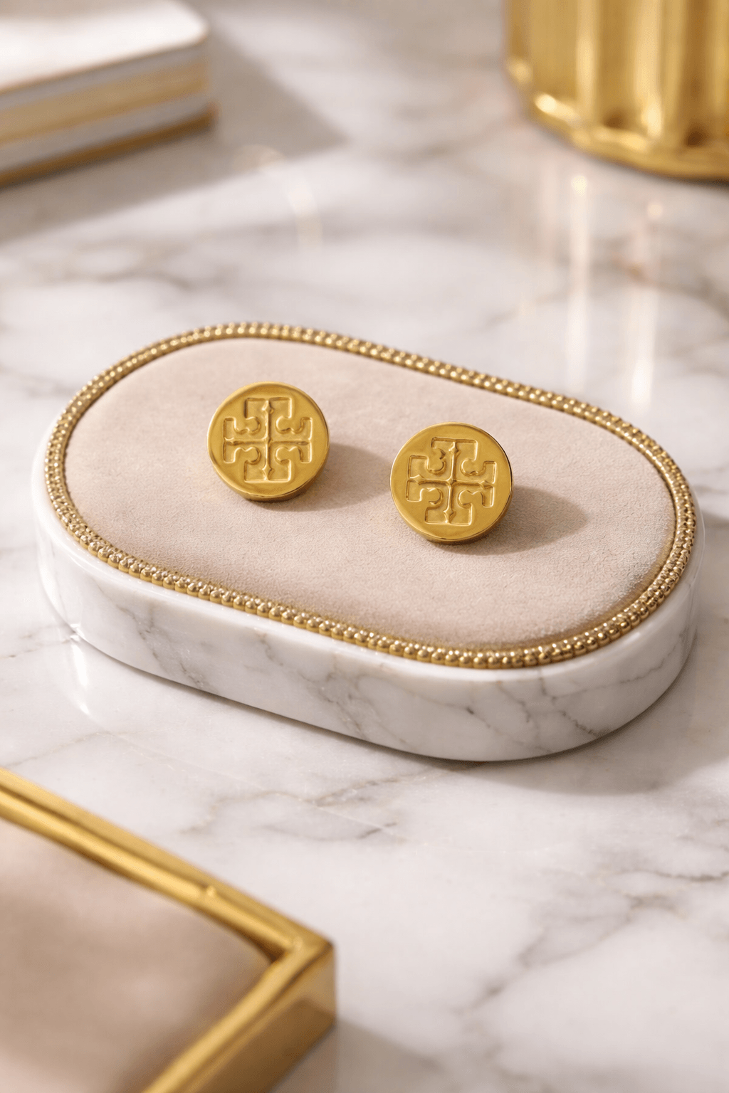Gold symbol stud earrings on marble jewelry display, perfect for gifting