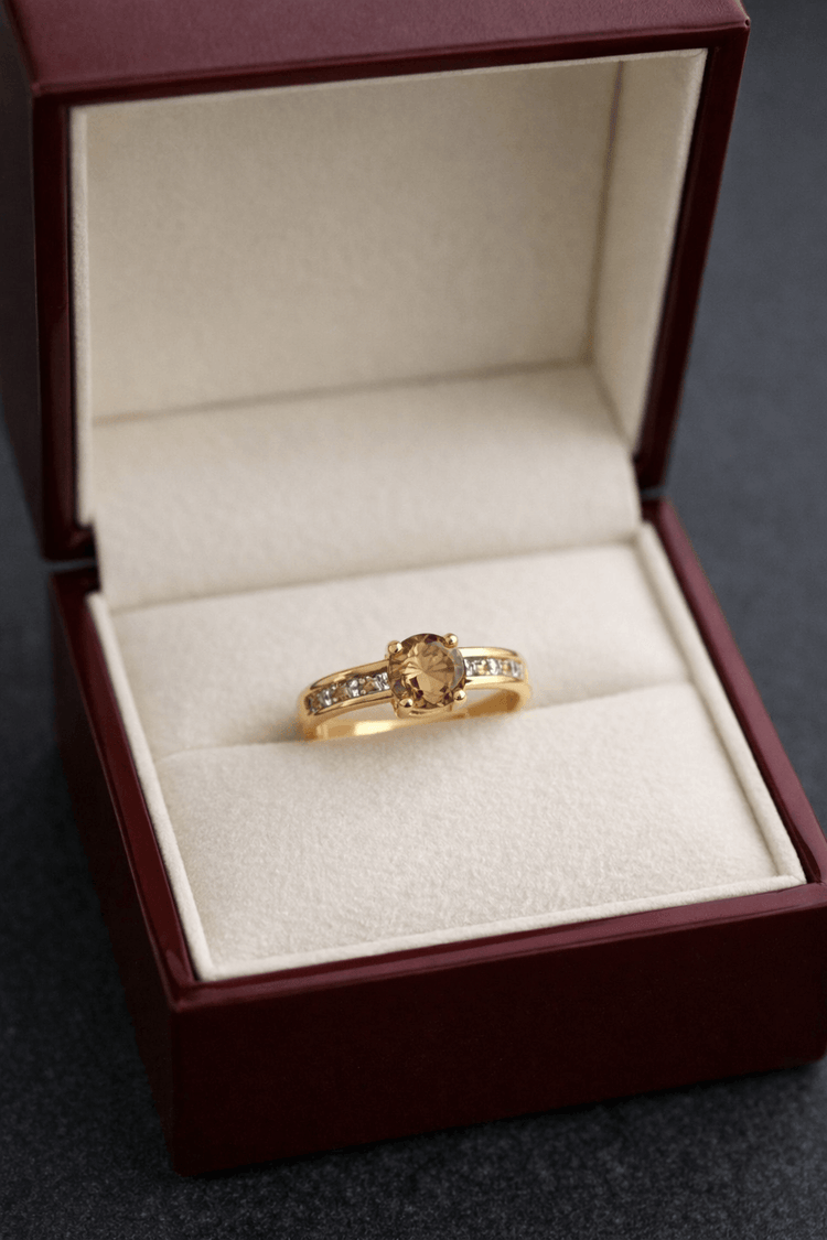 Gold ring with a gemstone in a jewelry box on a dark background