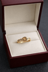 Gold ring with a gemstone in a jewelry box on a dark background