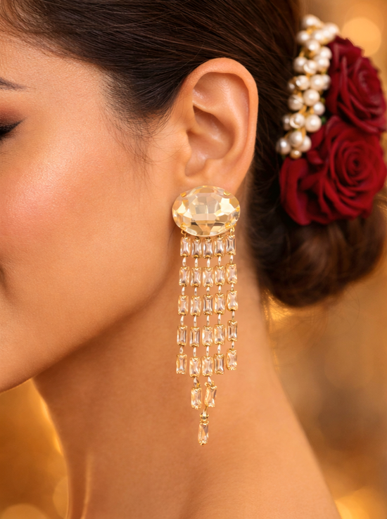 Close-up of a woman wearing gold earrings with a blurred background
