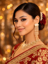 Woman in traditional red and gold outfit with jewelry against a blurred background