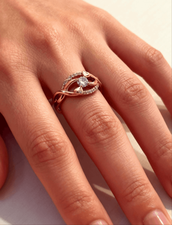 Rose gold ring with a diamond on a person&