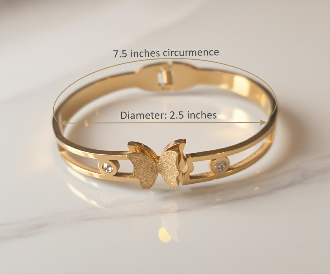 Gold bracelet with butterfly design and measurements on a light background