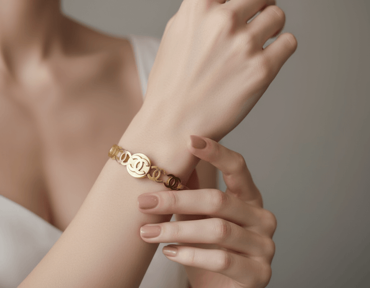 Gold bracelet on a black stand with blurred background