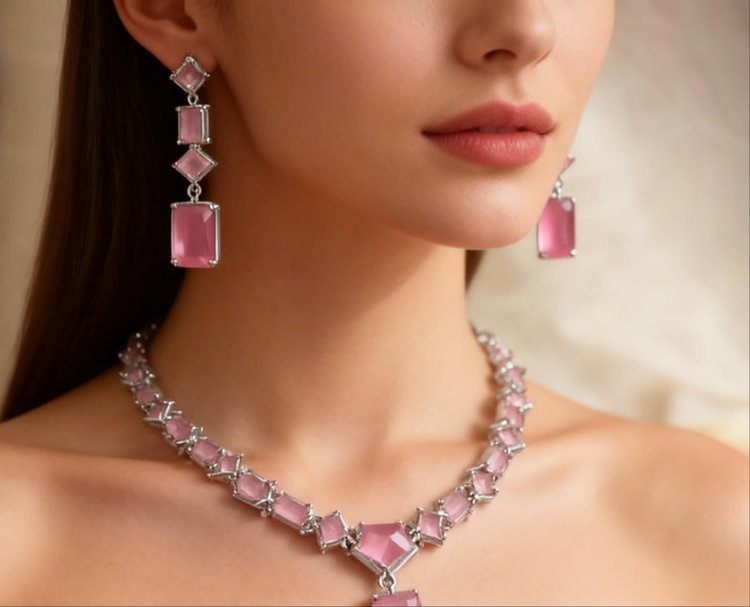 Pink gemstone necklace and earrings on a model