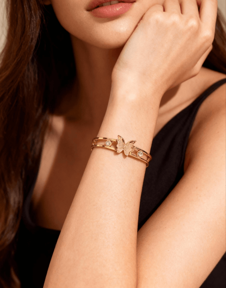 Rose gold bracelet with butterfly design on a woman&