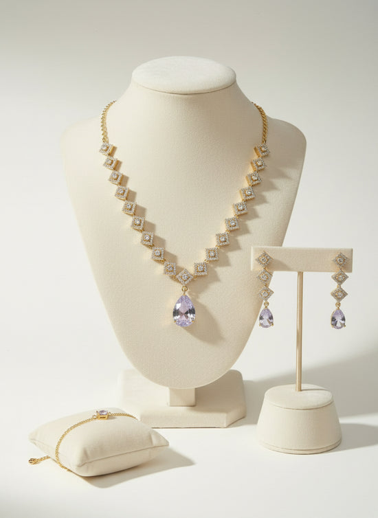 Jewelry set including necklace, earrings, and bracelet on a white background