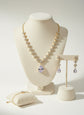 Jewelry set including necklace, earrings, and bracelet on a white background