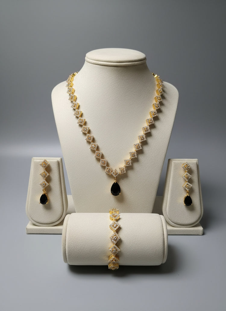 Jewelry set including necklace, earrings, and bracelet on a gray background