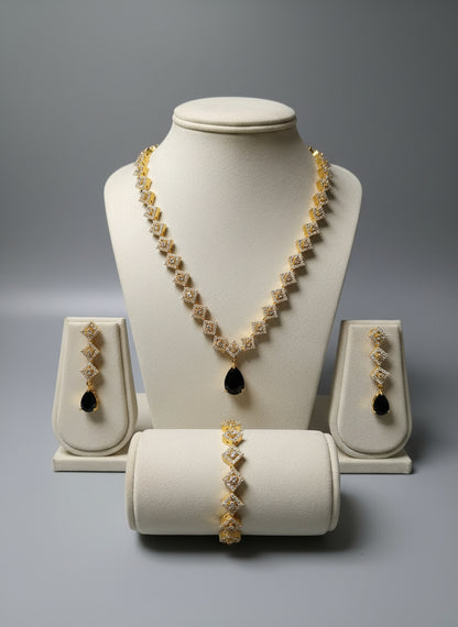 Jewelry set including necklace, earrings, and bracelet on a gray background