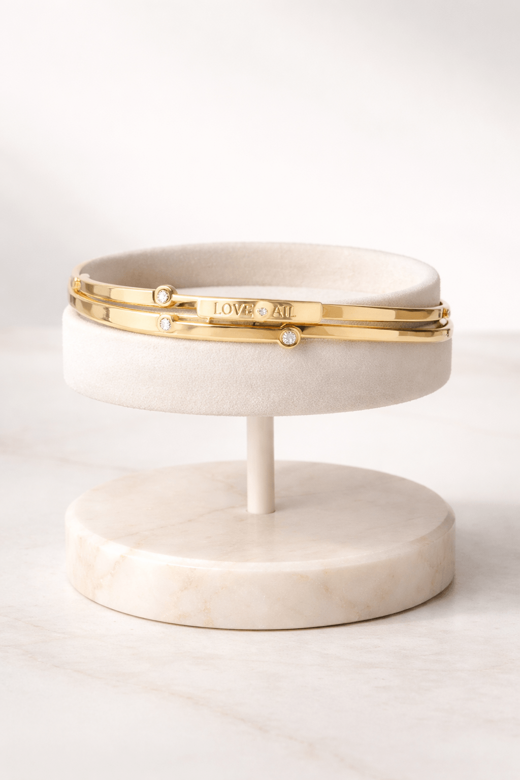 Marble jewelry stand with gold band on a white background