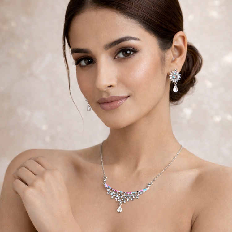 Woman wearing a necklace and earrings with a soft background