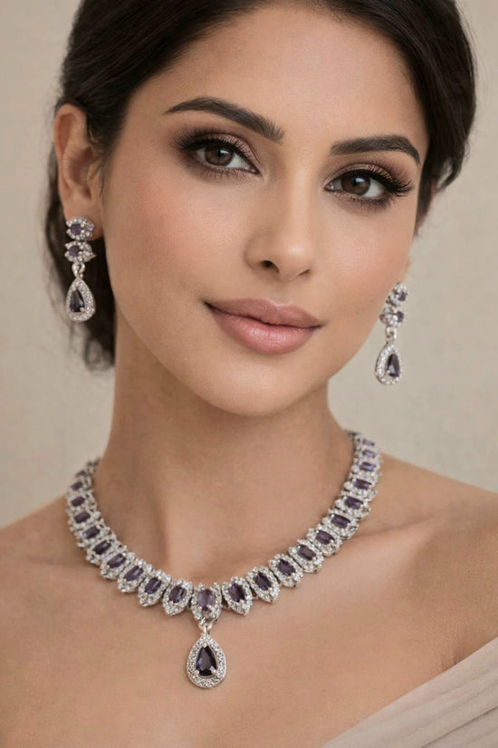 Woman wearing a luxurious diamond necklace and earrings on a neutral background