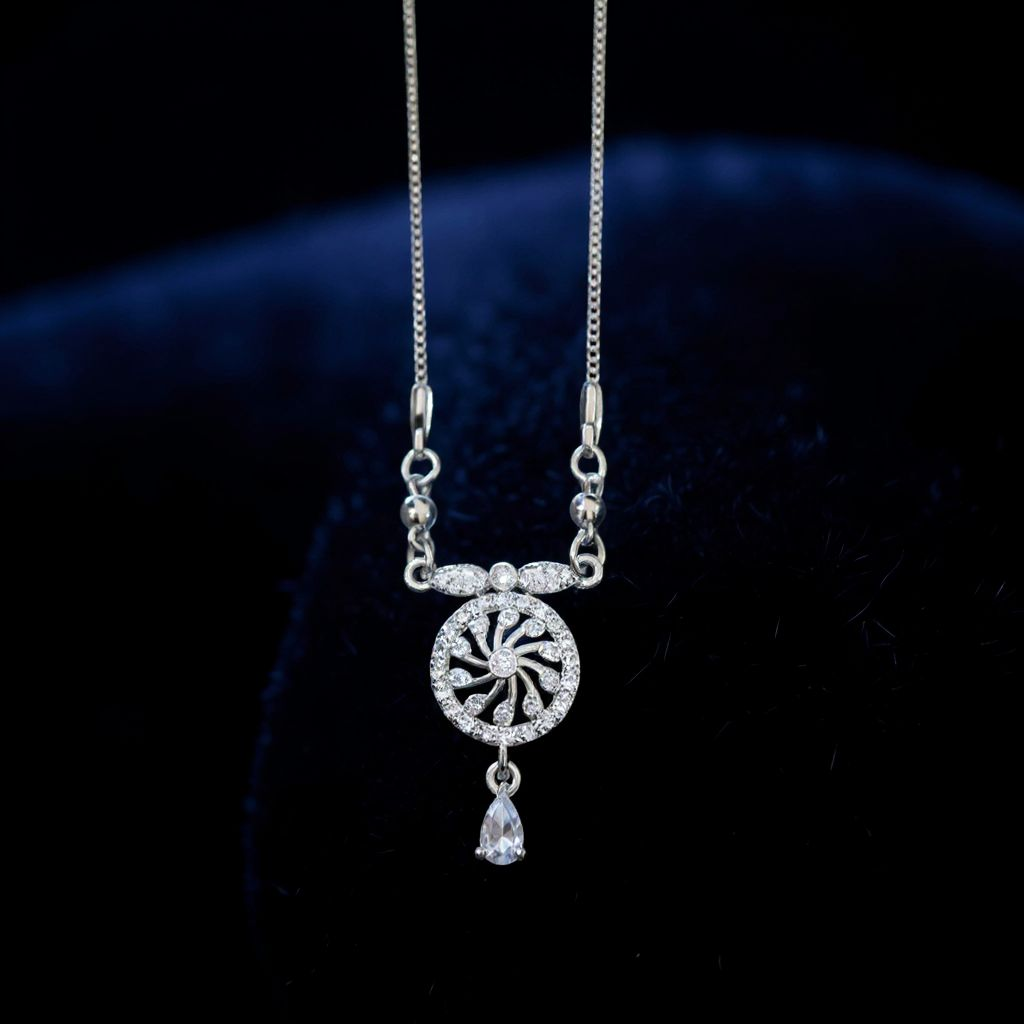 Silver necklace with a decorative pendant on a dark background