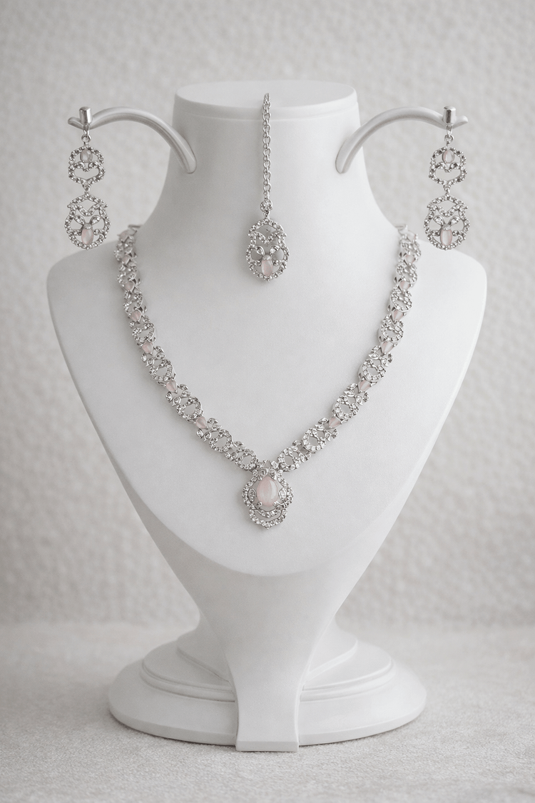 Jewelry set with necklace and earrings on a white mannequin bust.