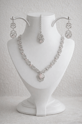 Jewelry set with necklace and earrings on a white mannequin bust.