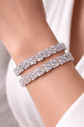 Two sparkling silver bracelets on a person&