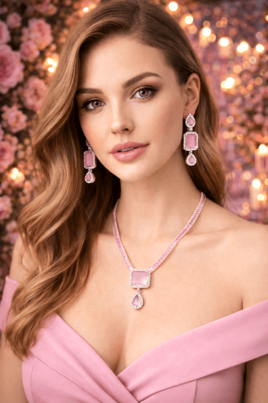 Woman wearing pink jewelry against a floral backdrop