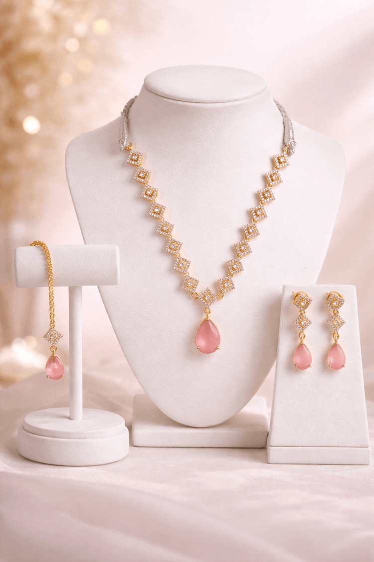 Jewelry set with necklace, bracelet, and earrings on a mannequin bust and stands.