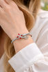 Silver bracelet with red gemstones on a person&