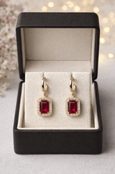 Elegant square-cut crystal drop earrings with red gemstones and diamond accents in a jewelry box