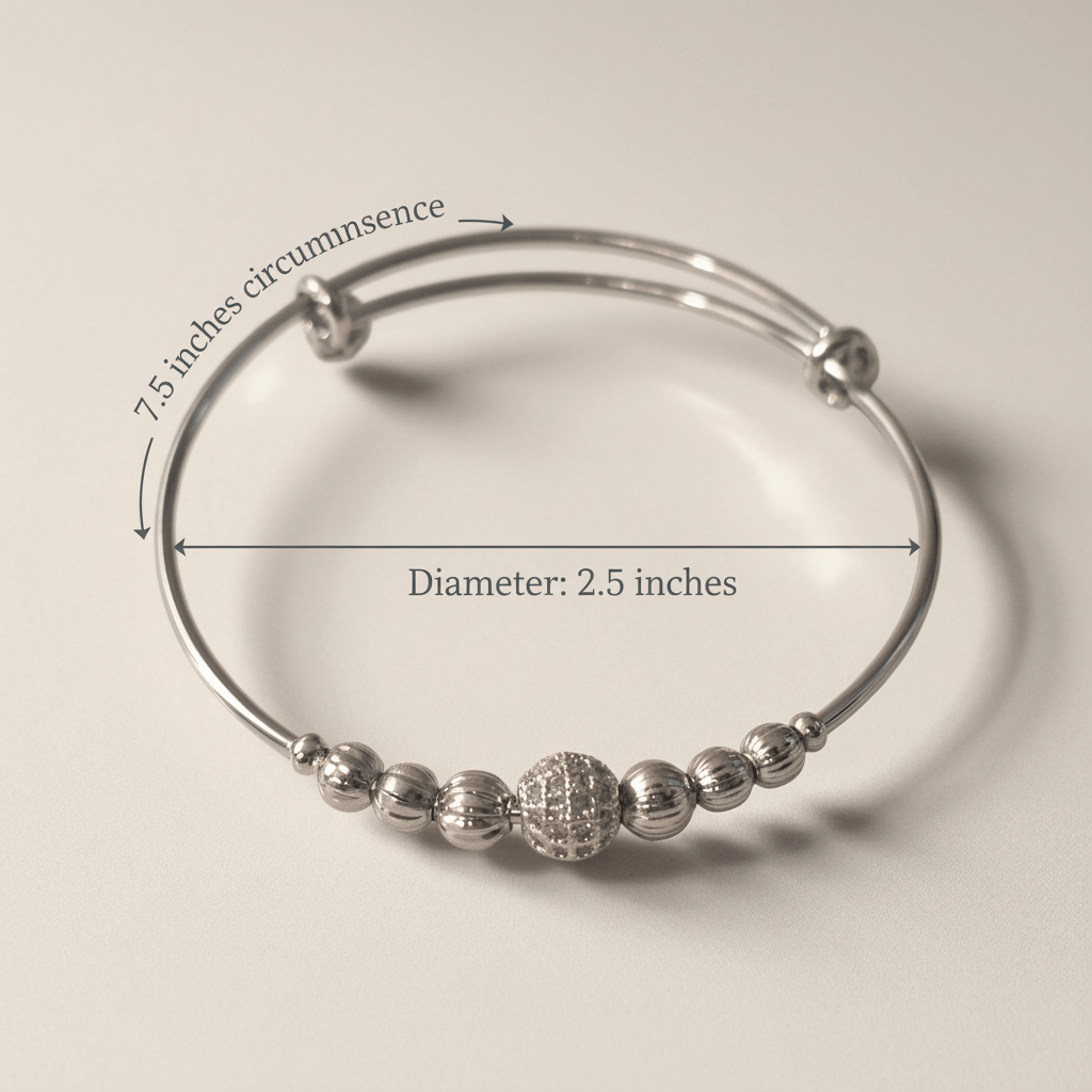 Silver beaded bracelet with measurements on a beige background