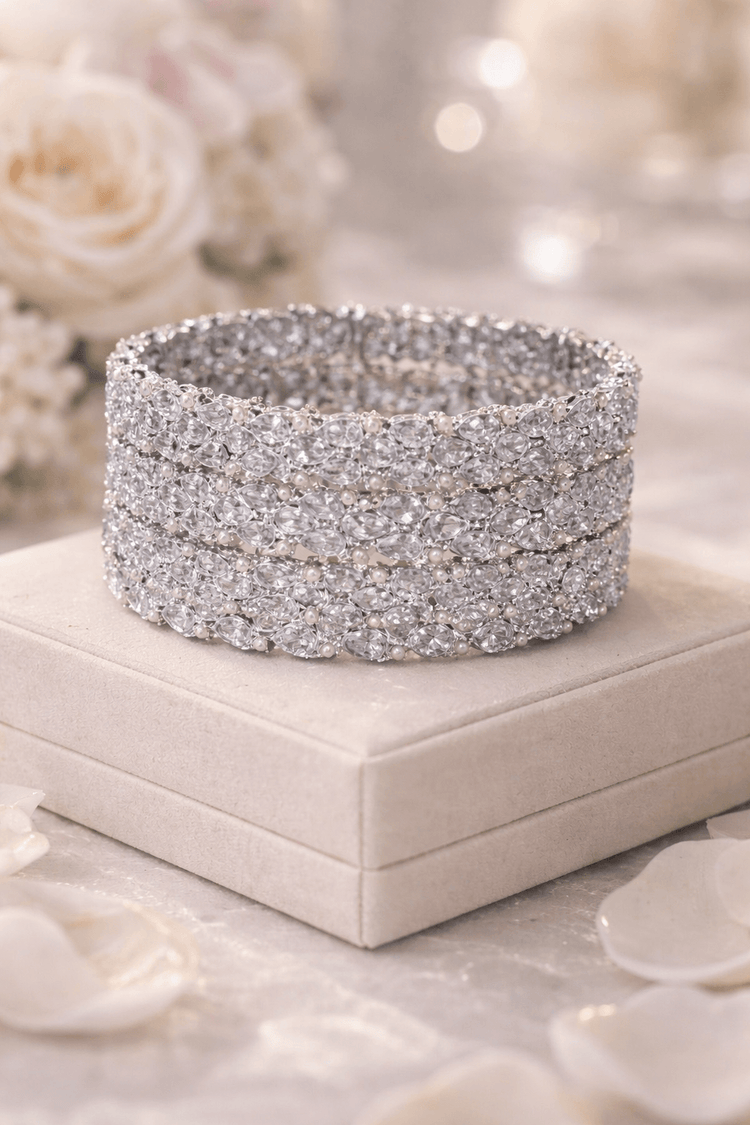 Silver glittery bracelet on a white jewelry box with floral background