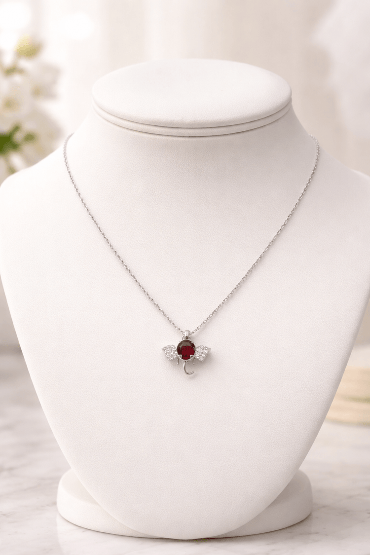 Necklace with a red pendant on a white mannequin bust.