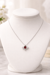 Necklace with a red pendant on a white mannequin bust.