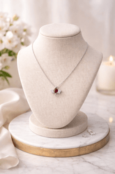 Necklace with a red gemstone on a mannequin bust with a soft background